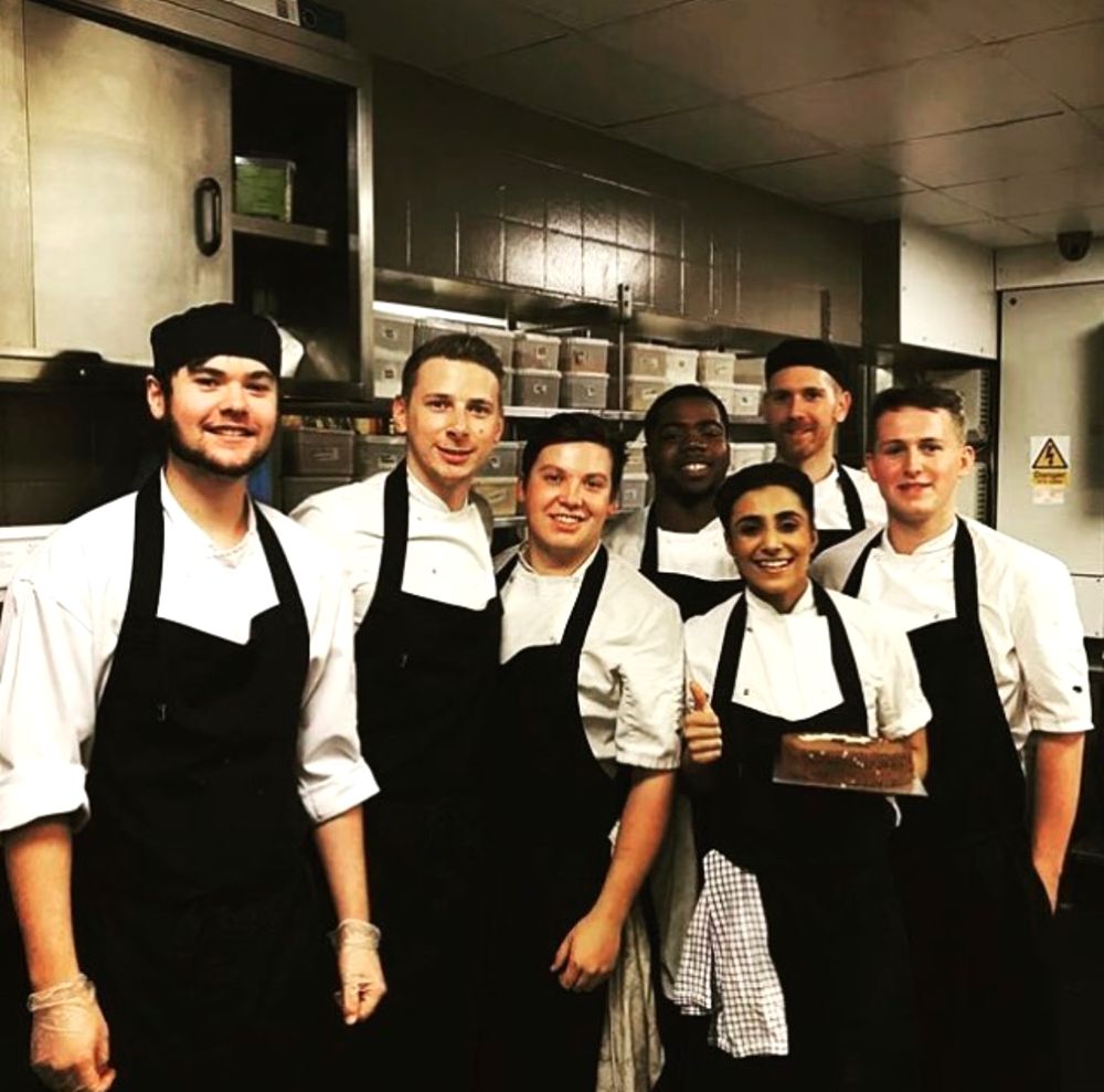 Ryan with a professional kitchen team in their whites